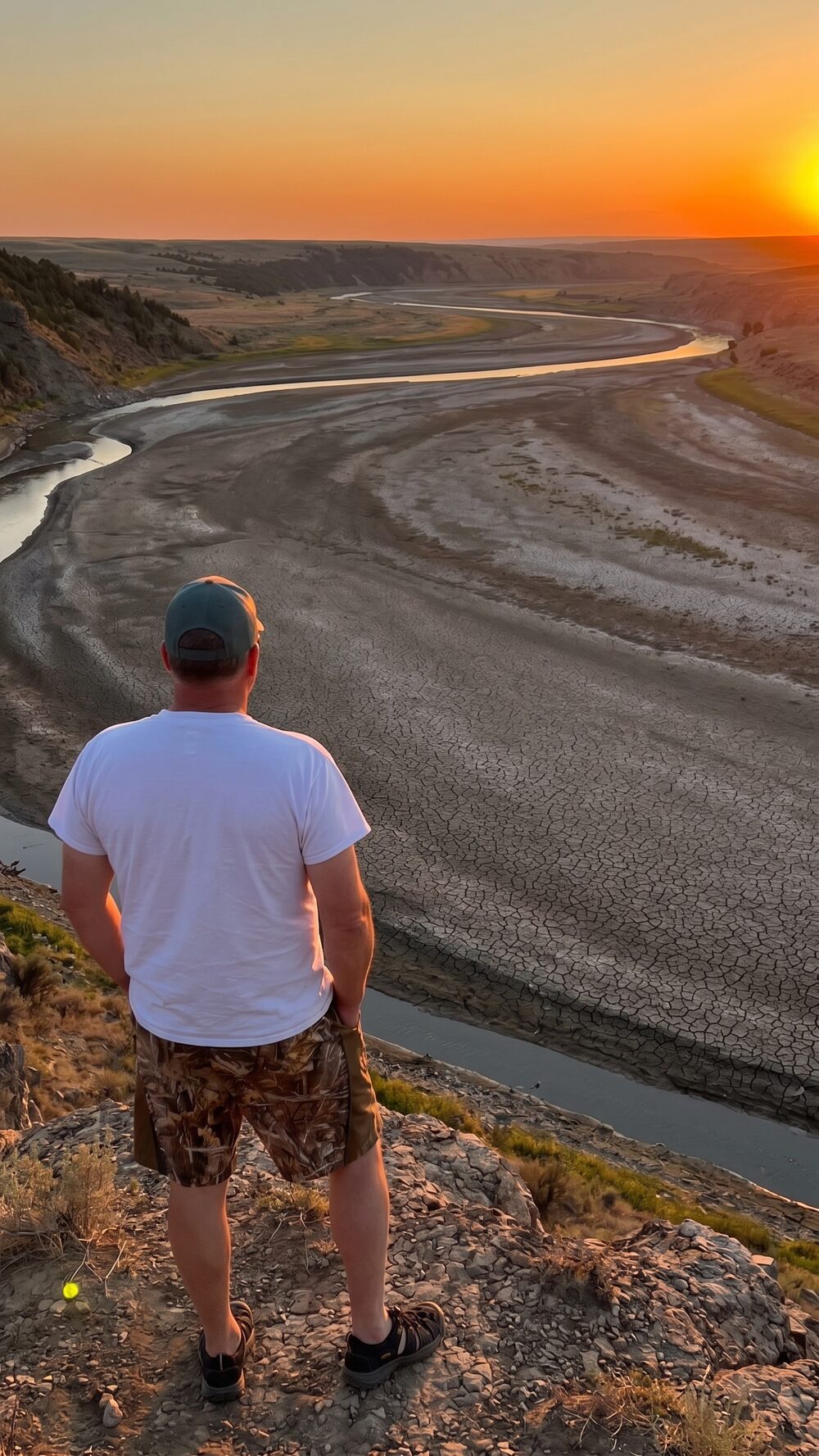 Troy Puls overlooking a drought-affected Wyoming river at sunset